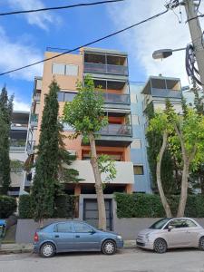 two cars parked in front of a building at Mary's vintage house in Athens