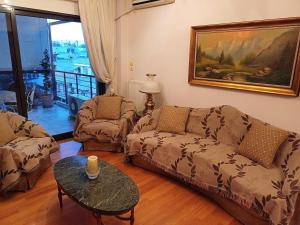 a living room with a couch and a table at Mary's vintage house in Athens