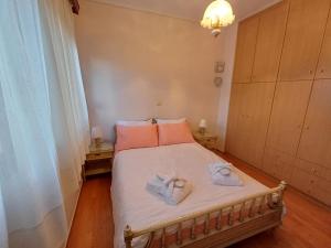 a bedroom with a bed with two towels on it at Mary's vintage house in Athens +29 photos