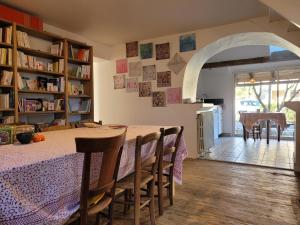a kitchen and dining room with a table and chairs at la maison du grand mas in Mouret