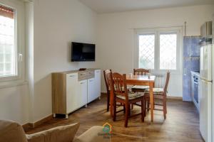 a kitchen with a table and chairs and a refrigerator at Dani's House in Isola Sacra