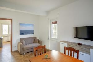 a living room with a couch and a table at Dani's House in Isola Sacra