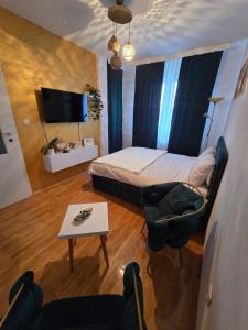 una piccola camera da letto con un letto e un tavolo di Apartman Rada 3 a Bijeljina