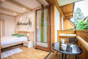 a small room with a bed and a glass table at Willa Vera Zakopane in Zakopane