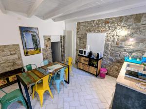 a kitchen with a table and chairs in a room at Casa colore intera casa nel borgo antico in Ossuccio