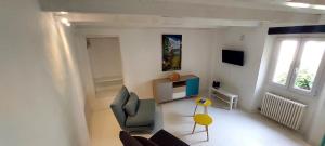 a living room with a couch and a chair at Casa colore intera casa nel borgo antico in Ossuccio
