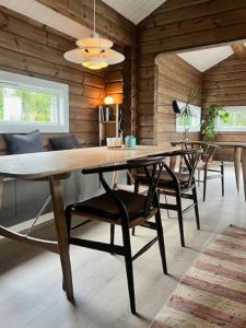 a dining room with a large wooden table and chairs at Mountain Cabin With Great Ski Terrain in Vingelen
