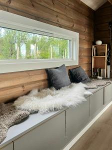 a room with two benches with a window at Mountain Cabin With Great Ski Terrain in Vingelen +28 photos