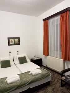 Postel nebo postele na pokoji v ubytování Aranyhídszálló