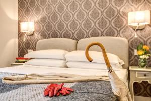 a hotel room with a bed with a broom on it at The Club Navona in Rome