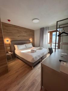 a hotel room with a bed and a desk at Lift Hotel in Sauze d'Oulx