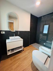 a bathroom with a sink and a toilet and a mirror at Lift Hotel in Sauze d'Oulx