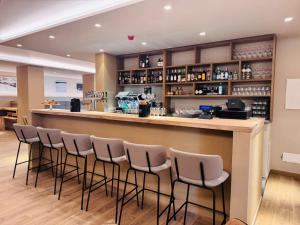 a bar in a restaurant with stools at Lift Hotel in Sauze d'Oulx +13 photos