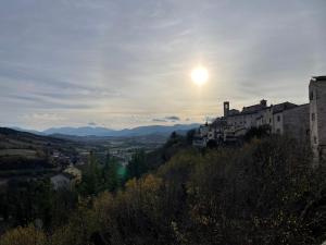 a view of the sun setting over a city at Casavacanzebrunella in Sassoferrato