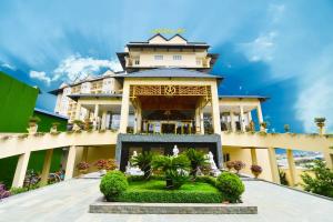 a building with a garden in front of it at Ladalat Hotel in Da Lat