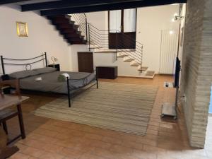 a room with a bed and a staircase at Casavacanzebrunella in Sassoferrato +4 photos