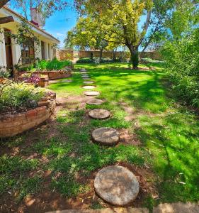 a garden with stepping stones in the grass at Home with The Hoffs in Smithfield