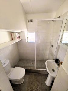 a bathroom with a toilet and a sink at Offbeat off Dorp in Stellenbosch +7 photos