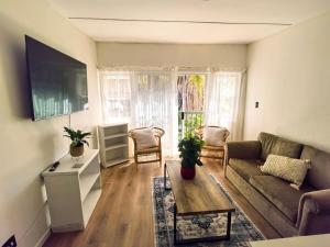 a living room with a couch and a table at Offbeat off Dorp in Stellenbosch