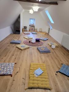 a room with several carpets on a wooden floor at la maison du grand mas in Mouret