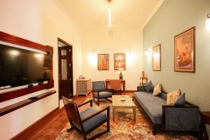 a living room with a couch and a flat screen tv at Gaj Kesri by 7Apple Resorts in Bikaner