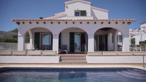 a villa with a swimming pool and a house at Villa Anita in Santo Tomás