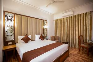 een hotelkamer met een groot bed en een bureau bij U by Z Hotels, Richmond Circle in Bangalore +43 foto's