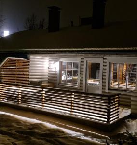a house with lights on the side of it at night at Arvoneliöt Lomahimos 18 in Jämsä +6 photos