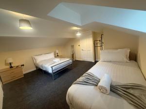 a bedroom with two beds and a desk in it at Rose Cottage by Sasco in Blackpool