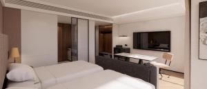 a bedroom with a bed and a desk and a television at Intercity Hotel & Serviced Apartment Phnom Penh Downtown in Phumĭ Prêk Chrey +9 photos