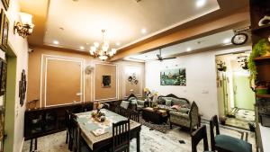a living room with a couch and a table at The Gulmohar Villa in Tājganj