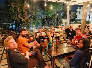 a group of people sitting around a table in a restaurant at Hoztel Jaipur in Jaipur +39 photos