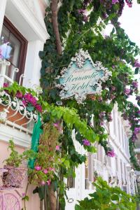 a street sign with flowers in front of a building at Romantic Hotel Istanbul in Istanbul