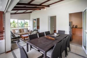 a dining room with a table and chairs at Three-bedroom at Jardin du Cap with shared pool in Cap Malheureux