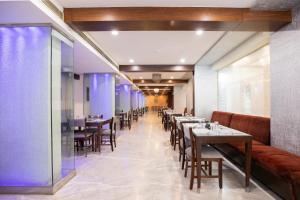 a row of tables and chairs in a restaurant at U by Z Hotels, Richmond Circle in Bangalore