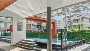 a swimming pool in the middle of a building at Dcondo Kathu - Top Floor 1 Bdr Condo with shared Pool in Kathu