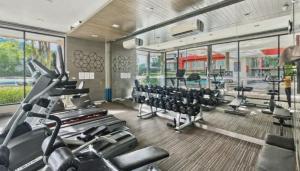 a gym with treadmills and elliptical machines at Dcondo Kathu - Top Floor 1 Bdr Condo with shared Pool in Kathu