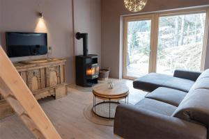 a living room with a couch and a fire place at chalet atelier Luxuriöses Chalet mit alpinem Charme in Telfes im Stubai +28 photos