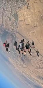 a group of people skiing down a sand hill at Vidanta in Nuevo Nayarit