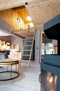 a room with wooden ceilings and a table and chairs at chalet atelier Luxuriöses Chalet mit alpinem Charme in Telfes im Stubai