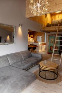 a living room with a couch and a table at chalet atelier Luxuriöses Chalet mit alpinem Charme in Telfes im Stubai