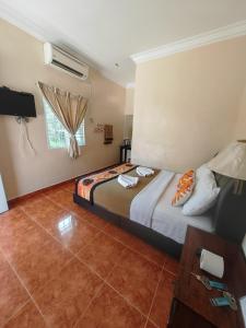 Ένα ή περισσότερα κρεβάτια σε δωμάτιο στο D Teratak Motel