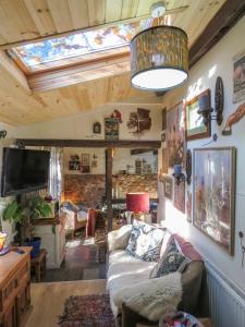 a living room with a couch and a skylight at Bluebell Cottage At Lurley Manor in Washfield