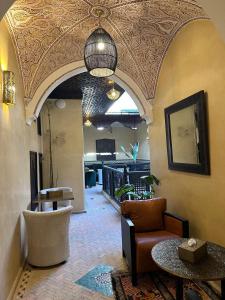 a living room with a couch and a table at Riad Jadis in Marrakesh +72 photos