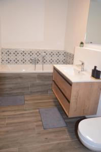 a bathroom with a sink and a tub and a toilet at Au pied de La Redoute in Sougné-Remouchamps +17 photos
