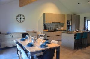 a kitchen with a table with glasses on it at Au pied de La Redoute in Sougné-Remouchamps