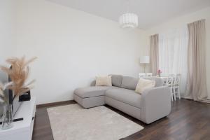 a white living room with a couch and a table at Pool & Cozy Apartment Warszawa Bukowińska by Solarento in Warsaw +10 photos