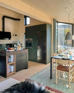 a kitchen with green cabinets and a table in a room at Stylish Mountain Cabin In Hallingdalen in Flå