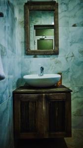 a bathroom with a sink and a mirror at Cj VILLA in Karatu +16 photos
