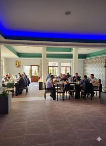 a group of people sitting at tables in a restaurant at Cornu Complex MEM in Campina +26 photos